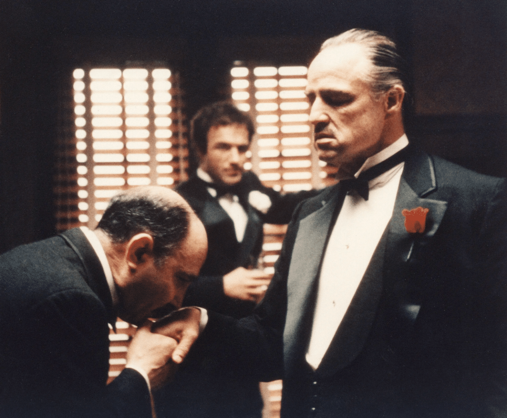 An image from The Godfather. The kissing hand scene showcases respect.