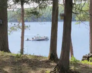 a small paddle boat is towed by two larger boats