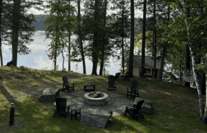 A cottage with a firepit and views of the lake