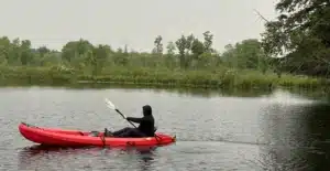 a Productive Shop team member is paddling a boat during the company retreat in the Kawartha Lakes 